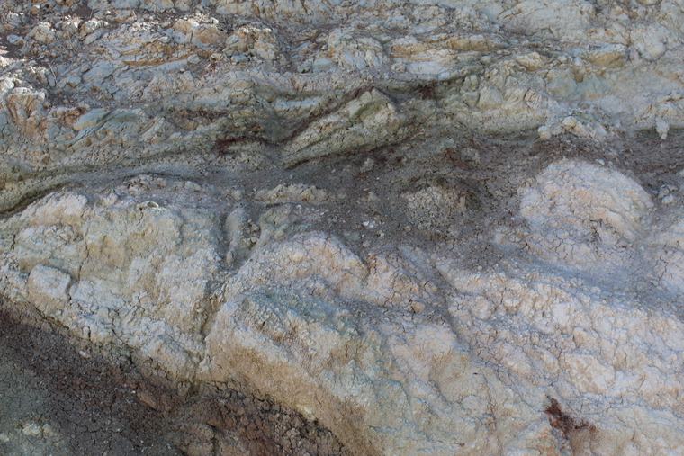 Strong reddish-brown oxide staining through a fracture zone