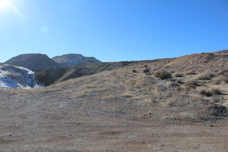 A numbered sample location on copper-stained rock