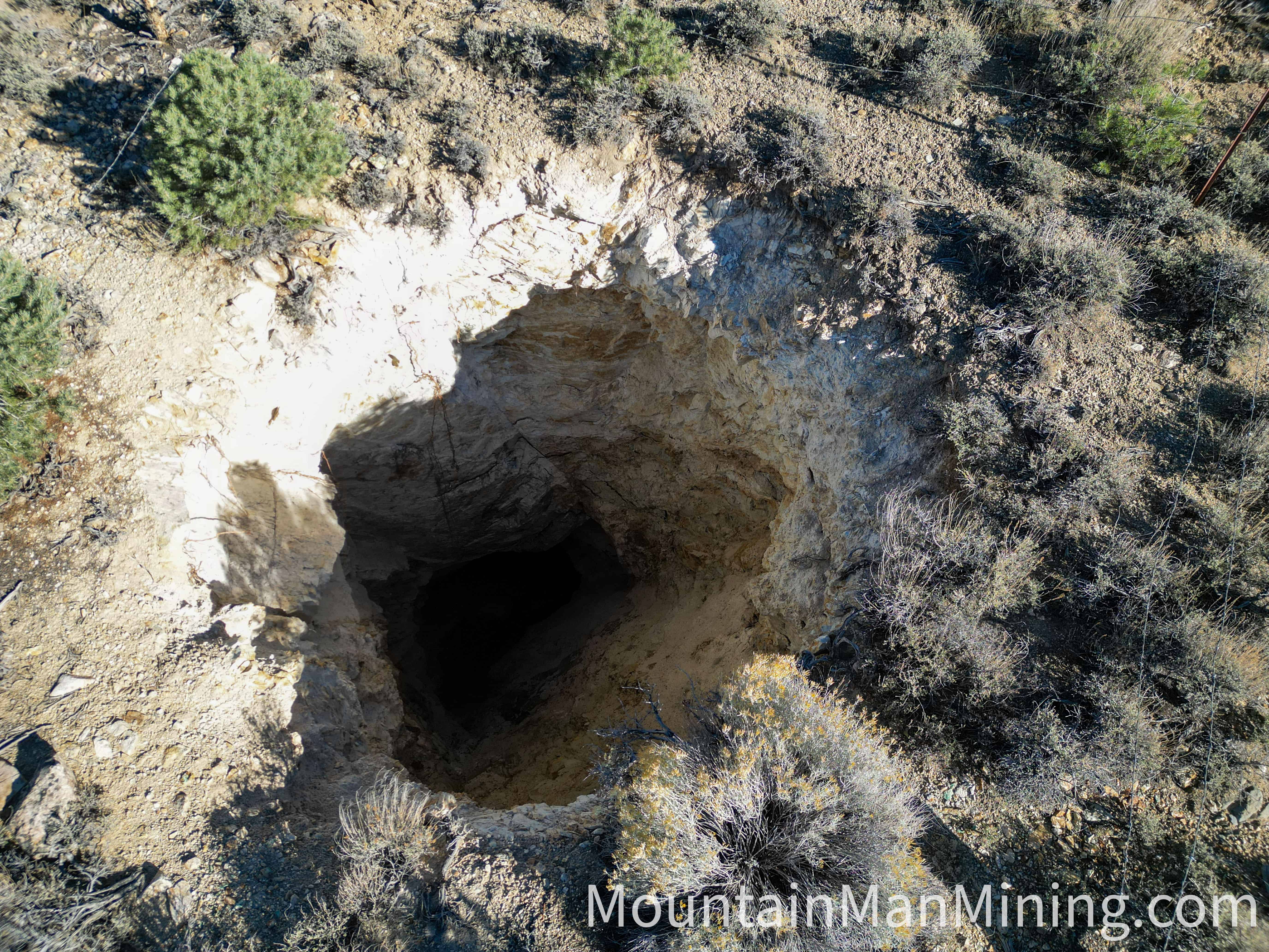 The Enriquez &mdash; Aerial view straight down the Enriquez shaft, with the rock cairn and claim monument beside it